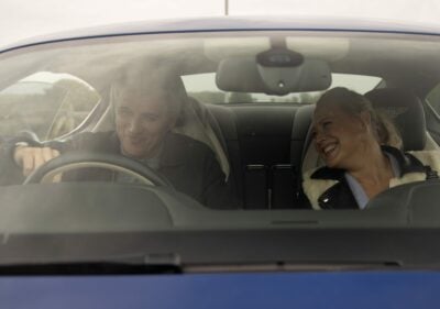 Tracy and Caleb laughing in a car on Emmerdale