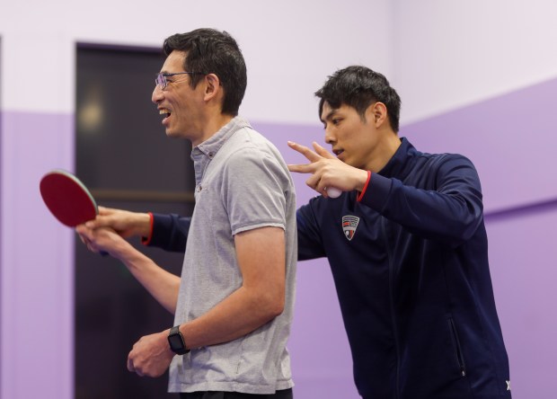 Walter Chang, of Cupertino, is taught technique by Jake Tu, table tennis coach from Burlingame, during a Parkinson's table tennis class at 888 Table Tennis Center in Burlingame, Calif., on Friday, Aug. 9, 2024. (Shae Hammond/Bay Area News Group)