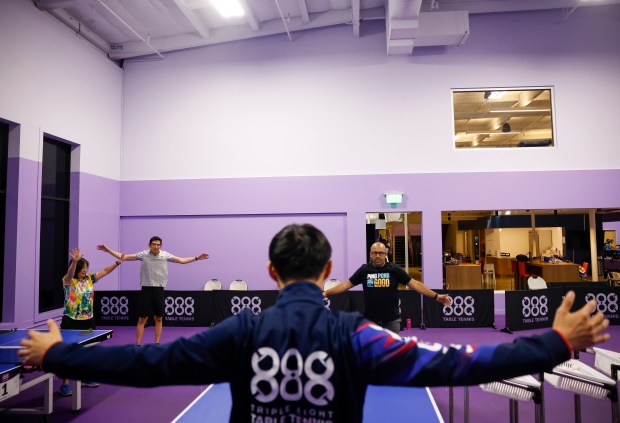 Jake Tu, of Burlingame, center, teaches a table tennis class...