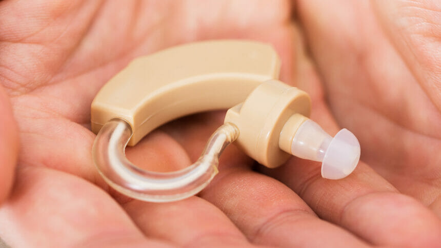 image of hearing aid held in hand