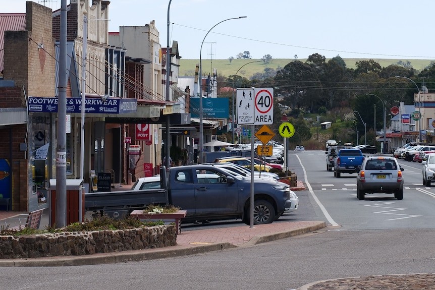 A main street in a country town full of cars