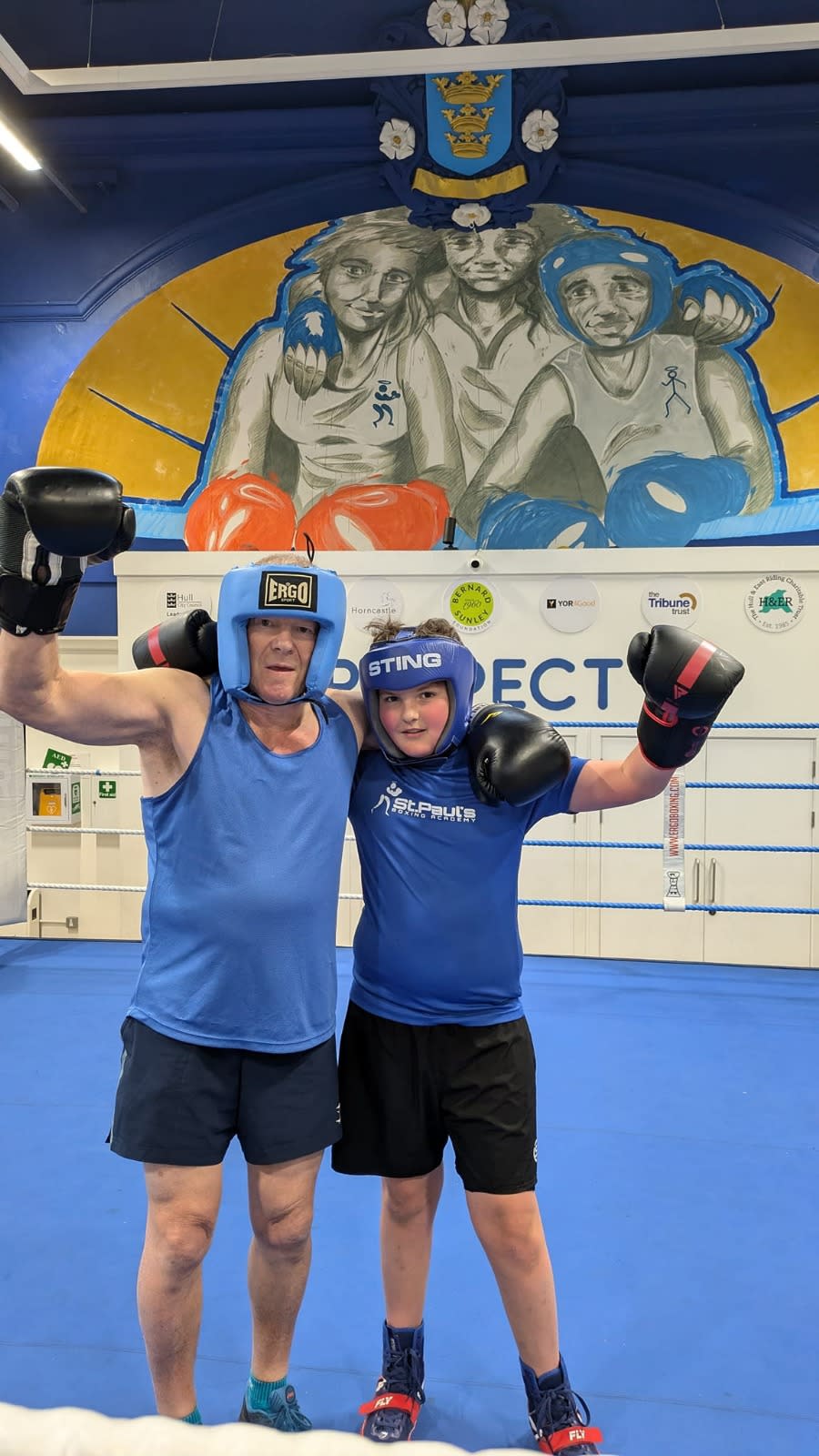 A man and his grandson in a boxing ring