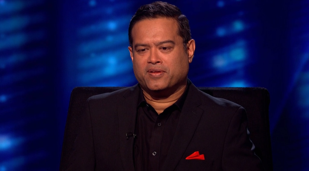 Man in black suit sitting on chair