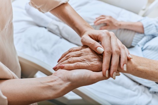 Relative holding trembling hand of senior woman with Parkinson's disease lying in hospital bed at medical ward. Diagnosis and treatment of Parkinson's disease and dementia Relative holding trembling hand of senior woman with Parkinson's disease lying in hospital bed at medical ward. Diagnosis and treatment of Parkinson's disease and dementia. (Getty Images/iStockphoto)