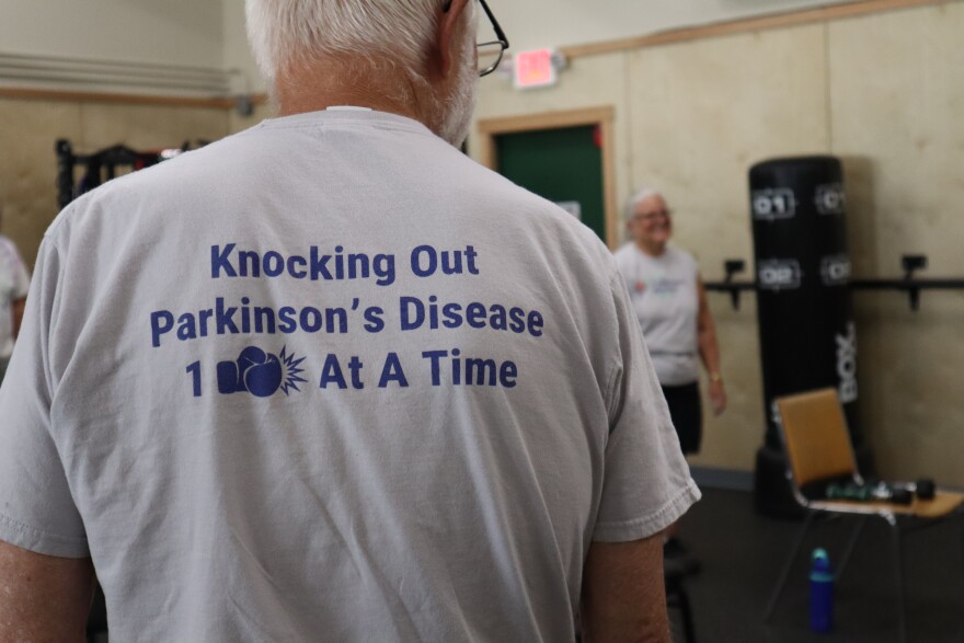 The back of each shirt sold by the Parkinson's Warrior Foundation reads "Knocking Out Parkinson's Disease 1 (punch) At A Time."