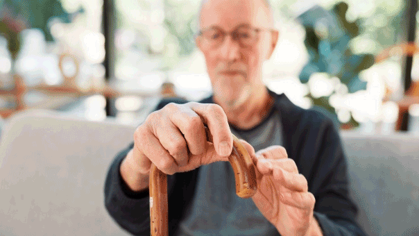 Man with Parkinson's disease holding cane