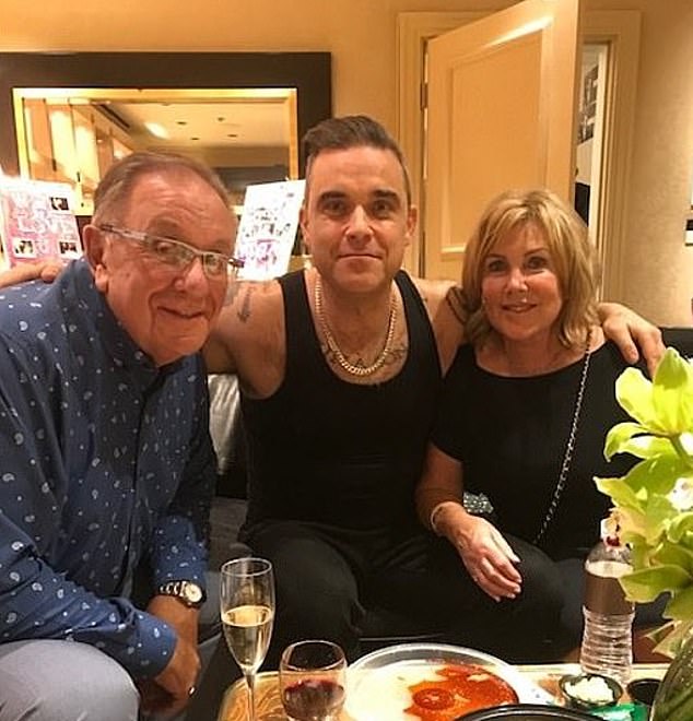 Robbie Williams has revealed his mother Janet has been diagosed with dementia. The diagnosis comes four years after the singer revealed his dad Pete had Parkinson's (pictured together in 2019)