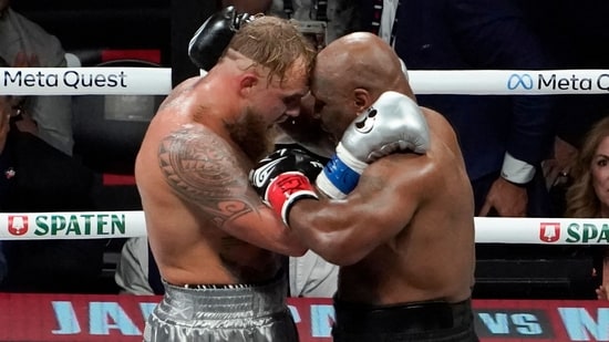 US YouTuber/boxer Jake Paul (L) and US retired pro-boxer Mike Tyson (R) hug at the end of their heavyweight boxing bout at The Pavilion at AT&T Stadium in Arlington, Texas, November 15, 2024. (Photo by TIMOTHY A. CLARY / AFP)(AFP)