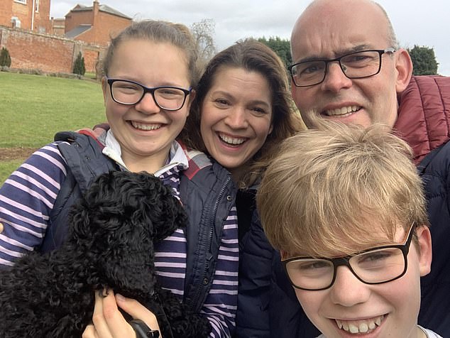 Kirsten Macpherson, who was told by doctors that her early Parkinson's symptoms were part of the menopause, with her children Freya and Fraser and husband Steve
